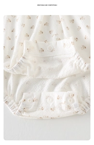 Détail du body bébé floral en coton respirant avec des boutons-pression à l'entrejambe