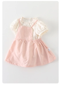 Detailed flat lay of baby girl floral top and pink pinafore dress set with puff sleeves
