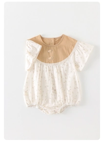 Detail of baby summer bodysuit with carrot appliques and floral ruffle sleeves