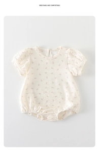 Detail of baby floral romper showing breathable cotton fabric and snap closure