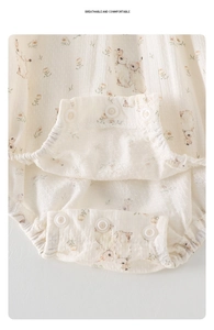 Detail view of baby bodysuit with snap closure and breathable floral cotton gauze fabric