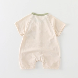 Short sleeve cotton baby romper in cream with green trim, flat lay back view