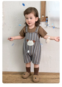 Close-up of cotton striped overall shorts featuring cute cartoon dog embroidery for baby boys