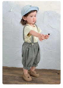 Baby-Sommerset mit gelbem T-Shirt, karierter Latzhose und Koala-Kinderschuhen