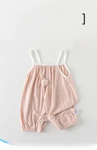 Close-up of pink baby summer bodysuit showing strawberry detail and snap buttons