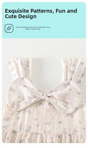 Detail of floral baby strap dress with bow and fluorescent-free cotton fabric texture