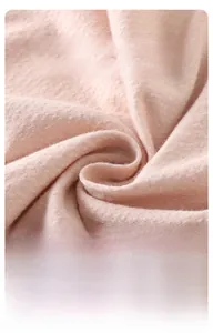 Close-up of soft pink modal fabric showing breathable, fluffy, and durable texture