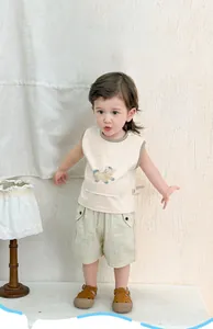 Breathable cotton baby boy summer vest and striped shorts set in soft lighting