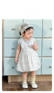 Detail view of baby girl floral dress with large bow accent and lace headband
