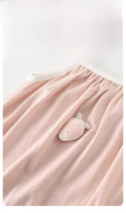 Detailed close-up of pink baby modal romper featuring a cute strawberry patch and white piping