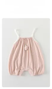 Close-up of baby girl pink cotton jumpsuit with strawberry applique and snap buttons
