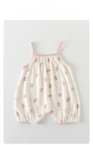 Detail of baby summer romper with strawberry print and breathable modal fabric