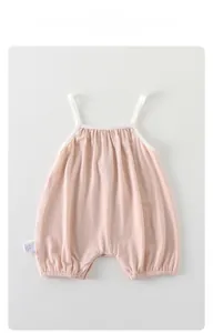 Detail of pink baby bodysuit showing breathable knitted mesh fabric and thin straps