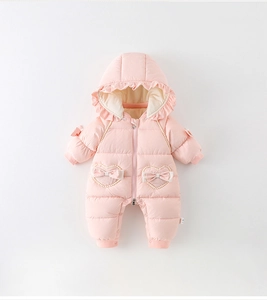 Close-up of pink baby winter romper with heart-shaped pockets and pearl bow details