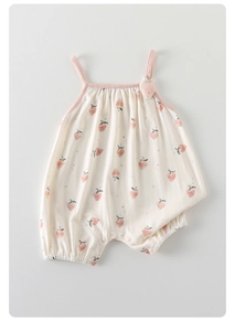 Close-up of baby strawberry romper with thin straps and convenient bottom snaps