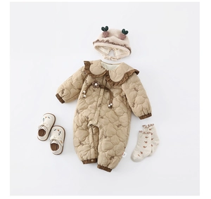 Mise à plat d'un ensemble barboteuse matelassée pour bébé avec col fleuri et accessoires