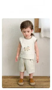 Detailed close-up of toddler summer vest and striped shorts with cute cartoon pony print
