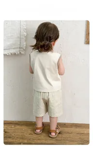 Back view of toddler summer set featuring beige sleeveless vest and striped shorts
