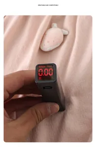 Testing light pink baby romper fabric for fluorescent agents with a digital meter