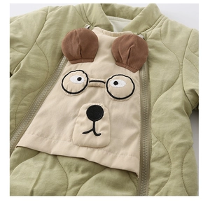 Close-up of baby romper with wave quilting and a cute cartoon puppy embroidery