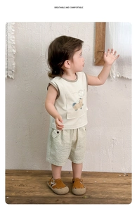 Close-up of boys sleeveless cotton set featuring a cream top with a cute animal pocket