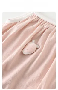 Detail of pink baby bodysuit with breathable honeycomb fabric and strawberry applique