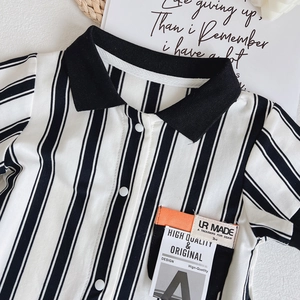 Infant short sleeve polo romper with black and white vertical stripes and pocket detail