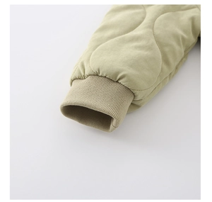 Close-up of quilted wave patterns and elastic ribbed cuffs on warm baby romper sleeves