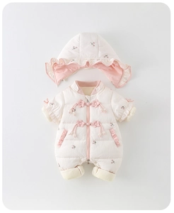 Detail of baby winter romper showing floral embroidery and elegant knot button closure