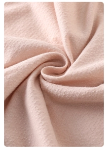 Close-up of soft pink modal fabric showing breathable knit texture and cozy fiber details