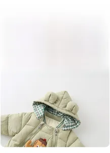 Detail of light green baby hooded romper with bear ears and green plaid lining detail