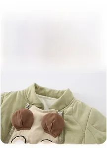 Detail of baby quilted romper neckline with cute 3D bear embroidery and metal zipper