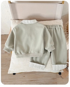 Detail view of boys gray-green leisure set featuring striped collar and ribbed cuffs