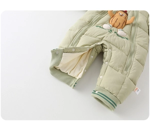 Detail of baby quilted romper showing nut cartoon applique and dual zippers with size 73 label