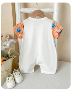 Detail of baby short sleeve romper with artistic oil painting print sleeves on wooden hanger