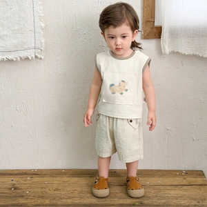 Boys summer two-piece outfit featuring a beige vest with horse pocket and striped shorts