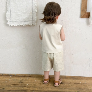 Toddler boy summer set featuring off-white sleeveless vest and striped shorts in cotton