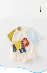 Detailed view of baby short sleeve bodysuit with color-block sleeves and lion print