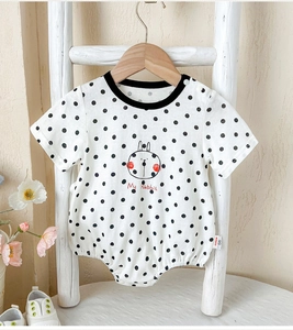 Detail of baby cotton polka dot romper featuring cute rabbit print and soft fabric texture