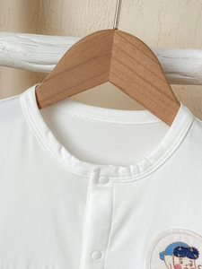 White short sleeve baby romper with cartoon embroidery and snap button closure