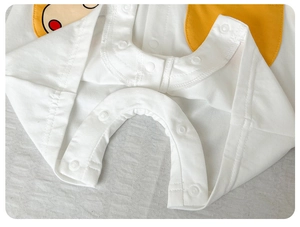Detailed macro shot of high-quality resin snap buttons on cotton baby romper crotch