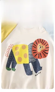 Detail of baby onesie with cartoon lion print and high-quality snap buttons on the collar