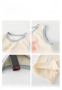 Detail view of cotton baby romper featuring waffle texture fabric and blue trim accents