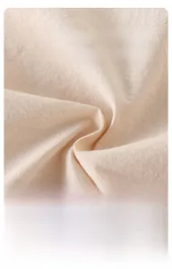 Close-up of soft breathable beige cotton fabric texture for baby summer rompers