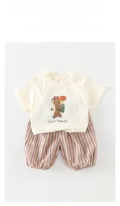 Detailed view of baby summer cotton T-shirt with bear print and striped shorts