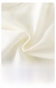 Close-up of soft breathable white cotton knit fabric for baby summer clothing set