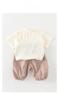Detail of toddler summer set showing breathable cotton T-shirt and striped shorts
