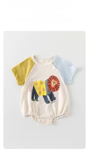 Detail of baby summer bodysuit with lion print, raglan sleeves and snap button closures