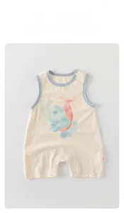 Detailed flat lay of a white sleeveless cotton baby romper with a blue trim and elephant print