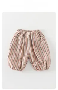Detail of children's striped bloomers with elastic waist and side pockets in cotton linen